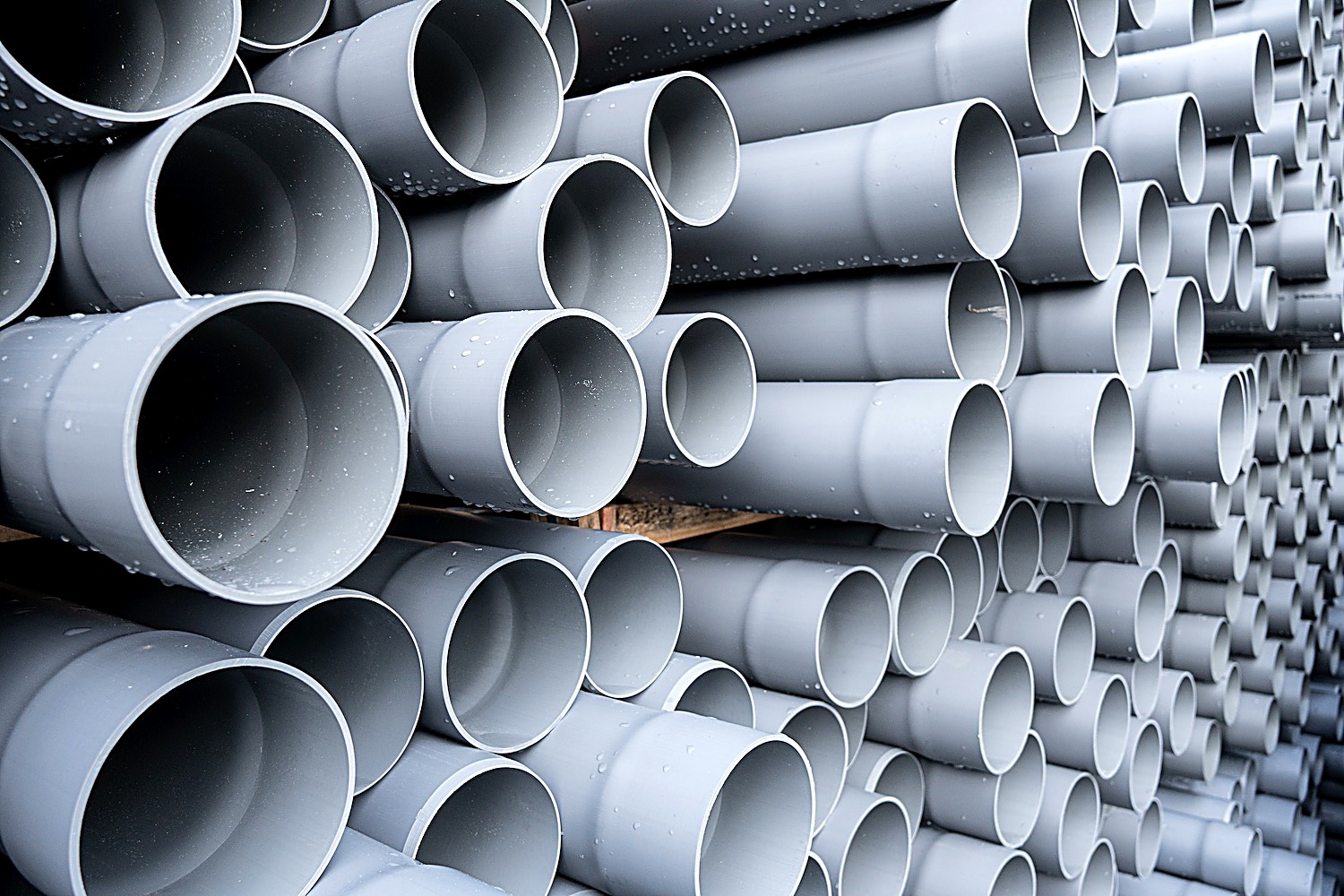 Stacked grey PVC irrigation pipes